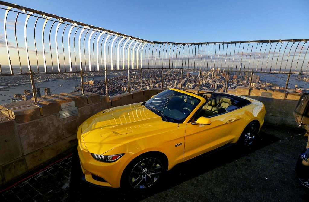A 2015 Ford Mustang convertible, assembled overnight as part of a publicity stunt, sits on the observation deck of the Empire State Building in New York.